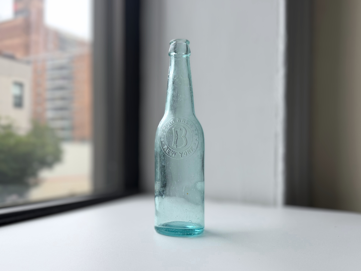 Aqua glass Fidelio Brewery bottle displayed on a windowsill, early 1900s NYC breweriana.
