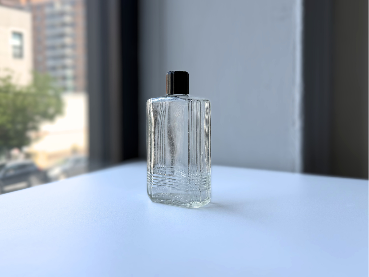 Mennen bottle 1952 clear Art Deco glass on windowsill, NYC beach recovery