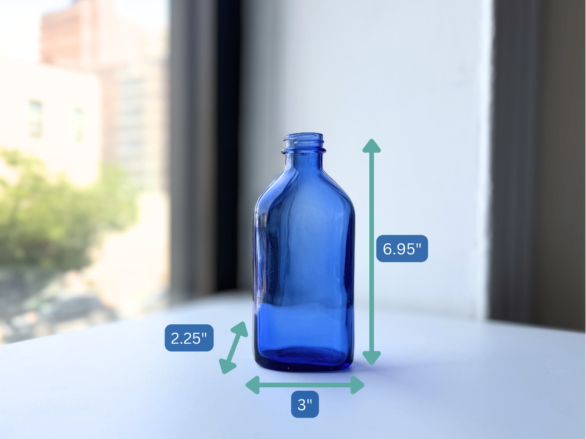 Phillips bottle with dimension overlay showing 7 inch height, cobalt blue glass