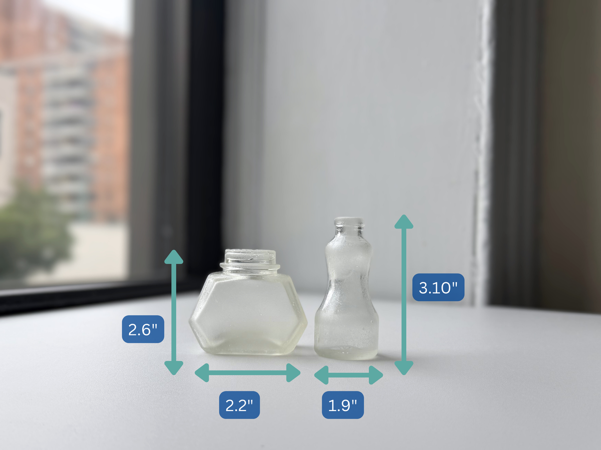 Sea-worn ink bottle pair with dimension overlay showing height and width for each bottle.