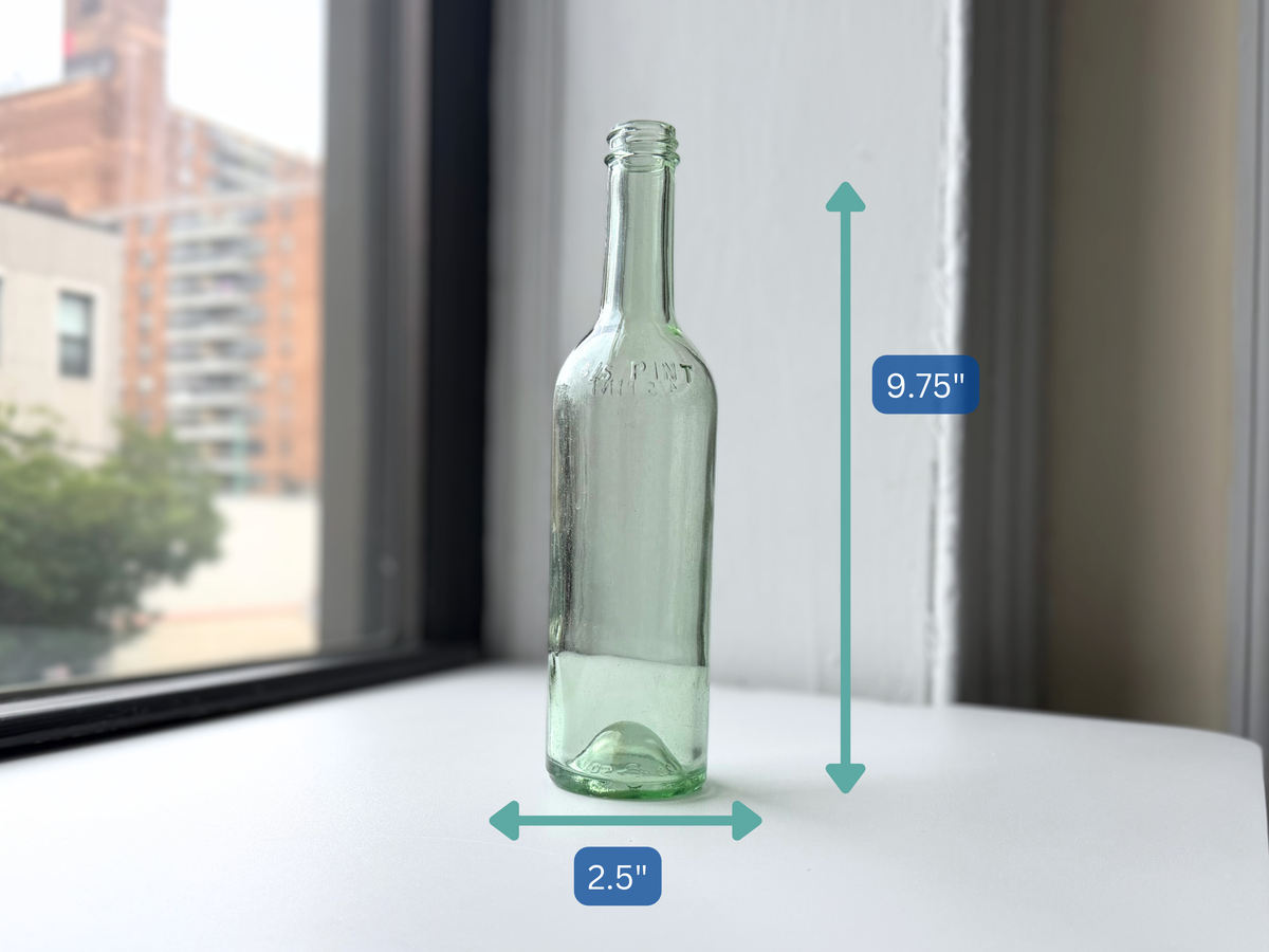 Pale green glass bottle with height measurement overlay showing 9.75 inches.