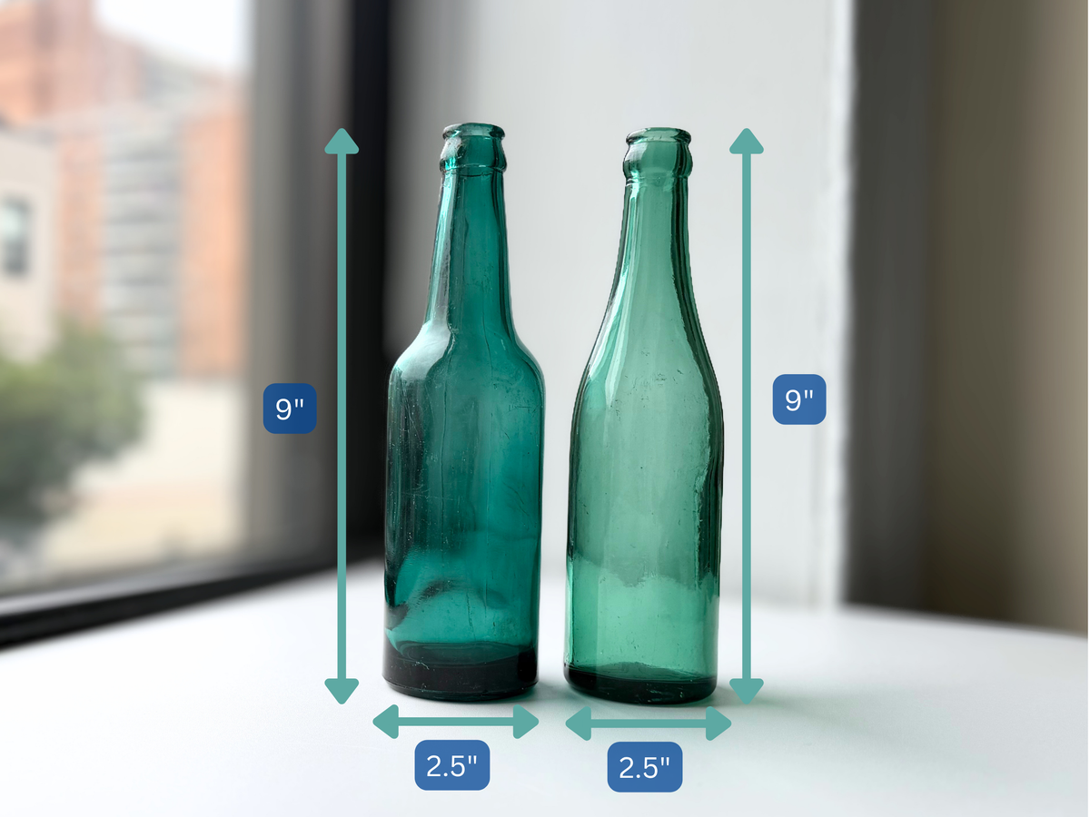 Teal glass beer bottle pair with dimension overlay showing 9 inch height and 2.5 inch width for each bottle.