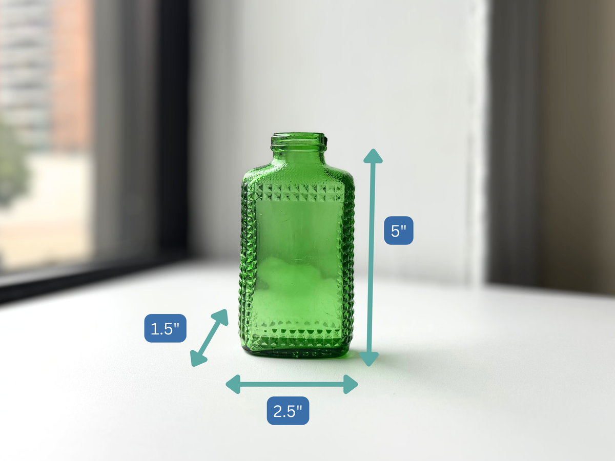 Vintage kelly green Airwick hobnail glass bottle with height and width measurement overlay