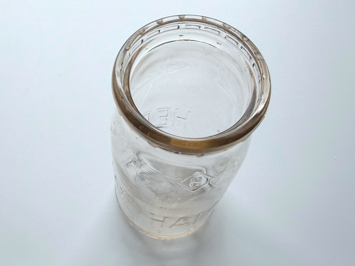Top-down view into the open mouth of a Hegeman Farms milk bottle.