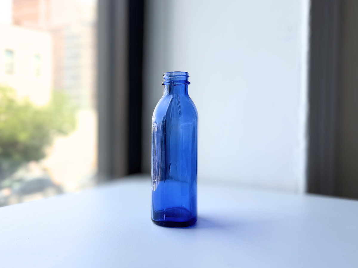 Tall Phillips cobalt blue bottle front view, slender silhouette