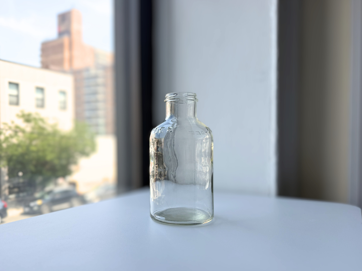 Vintage clear glass DAN-DEE jar viewed straight-on, showing embossed lettering