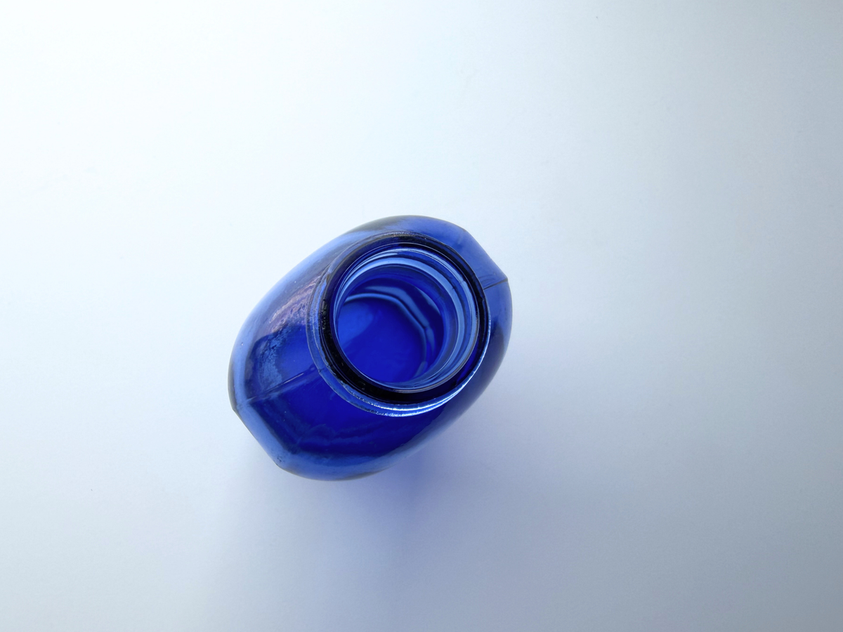 Phillips cobalt blue bottle top-down view into open mouth