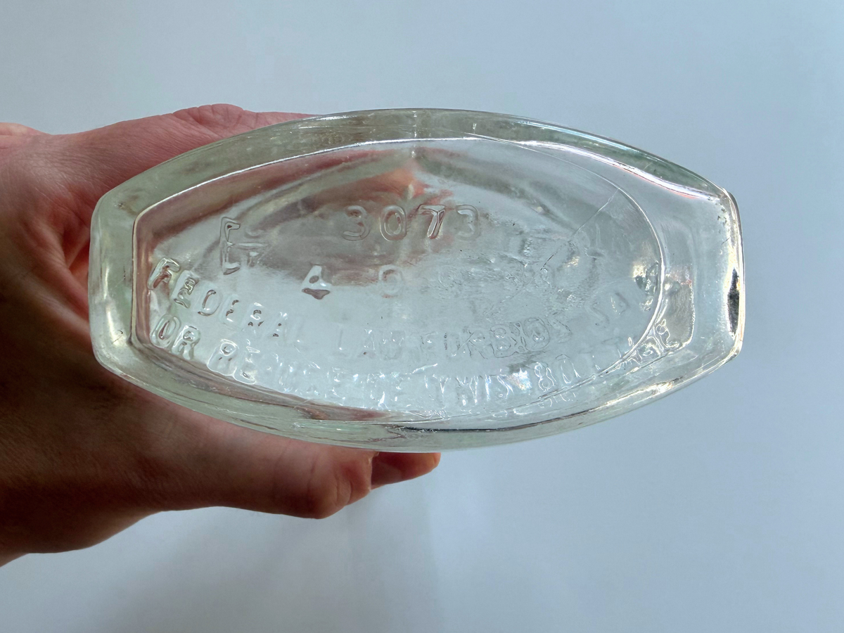 Close-up of the Art Nouveau scrollwork and floral pattern on a Schenley decanter.