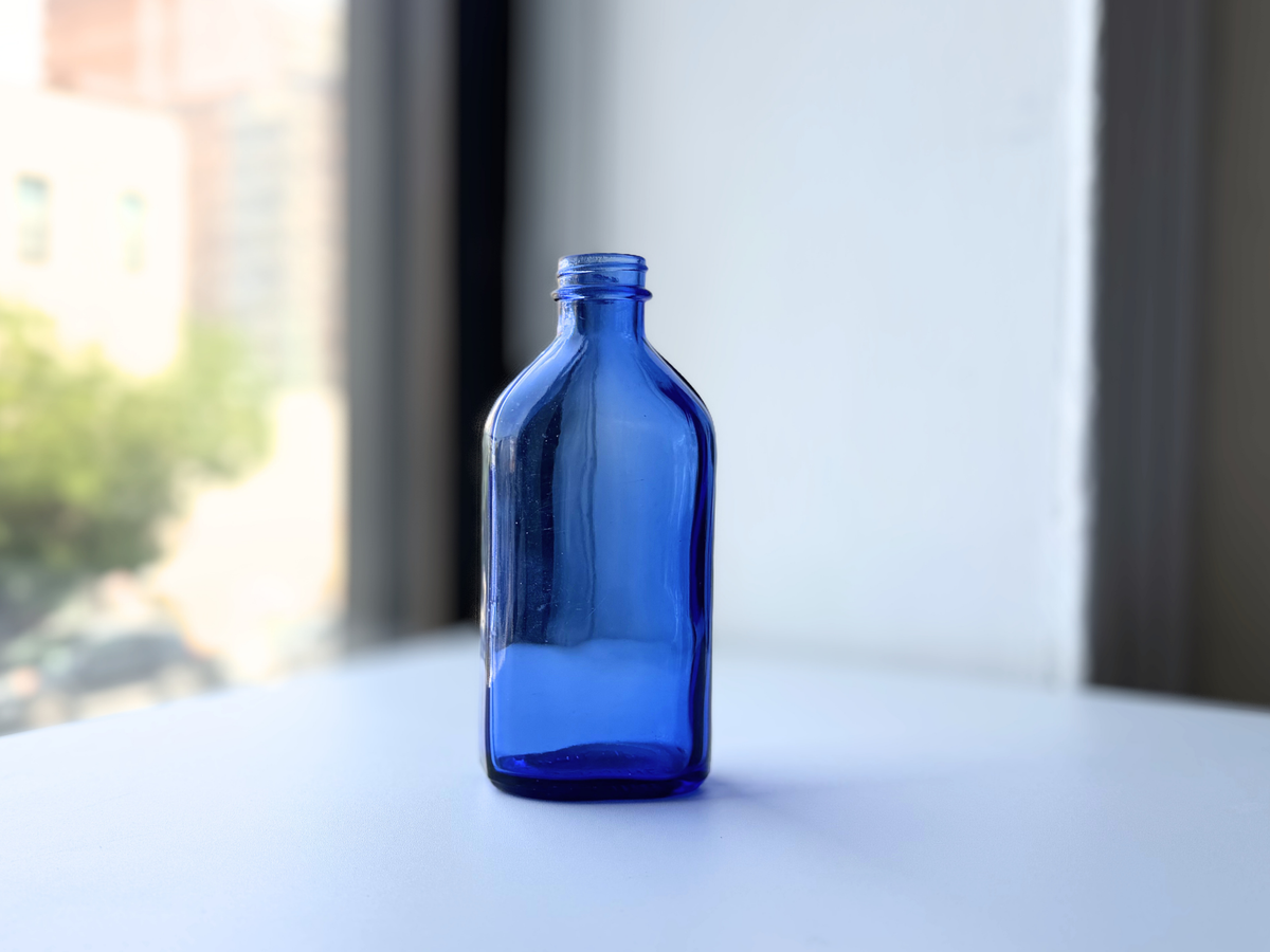 Tall Phillips cobalt blue bottle three-quarter angled view