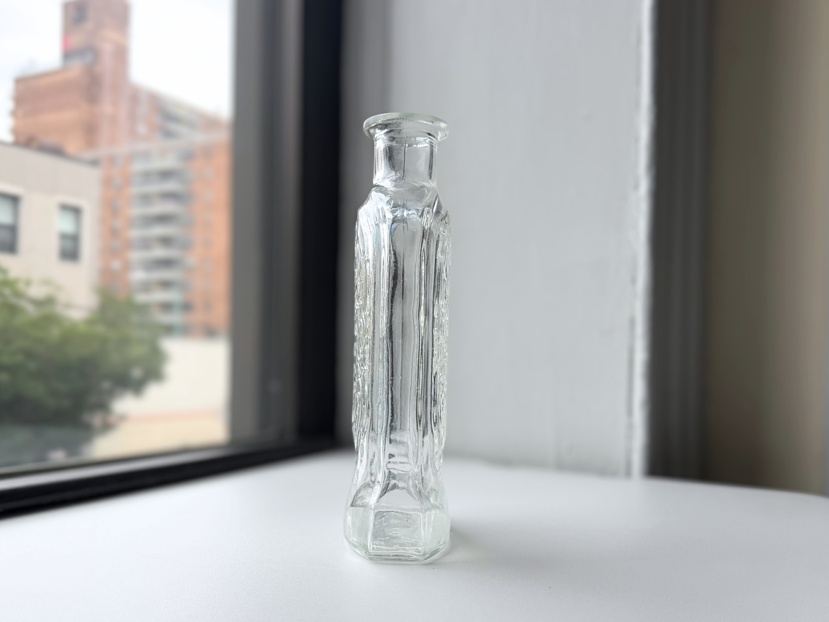 Schenley decanter displayed on a windowsill with Brooklyn brownstones in the background.