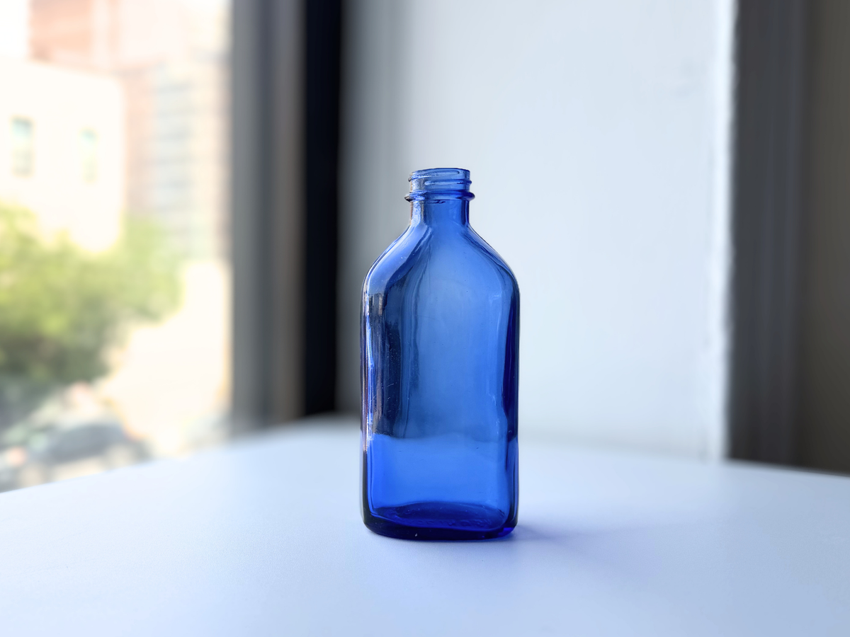 Phillips cobalt blue bottle close front view showing glass texture