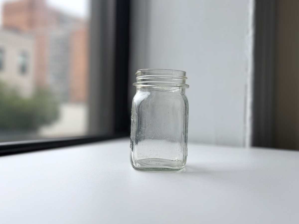 Anchor Hocking mason jar on a windowsill with Brooklyn brownstones in the background.