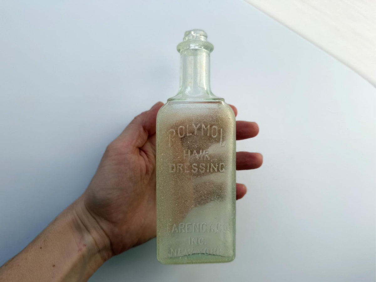 Antique aqua Polymol Hair Dressing bottle with genuine sea-worn ocean patina. Early 20th century New York glass transformed by decades at sea into frosted sea glass. Perfect beach house decor and vintage collector piece.