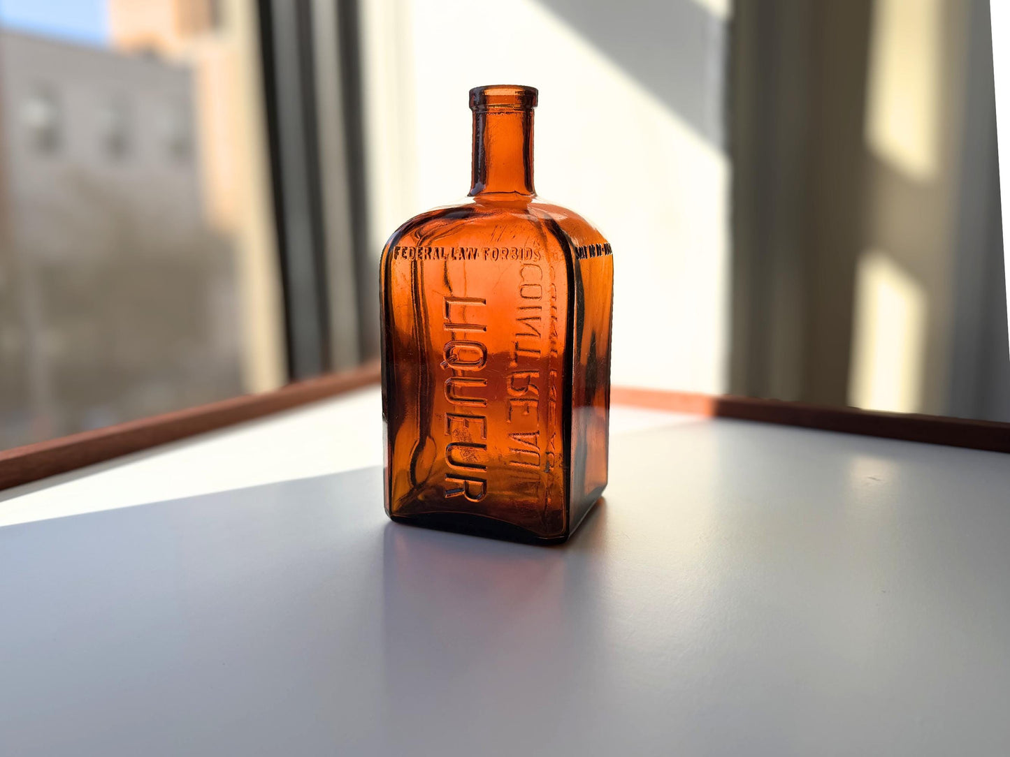 Vintage 1951 large amber Cointreau bottle with 51 production marking. Perfect for spirits collectors, bar displays, and vintage liqueur enthusiasts.