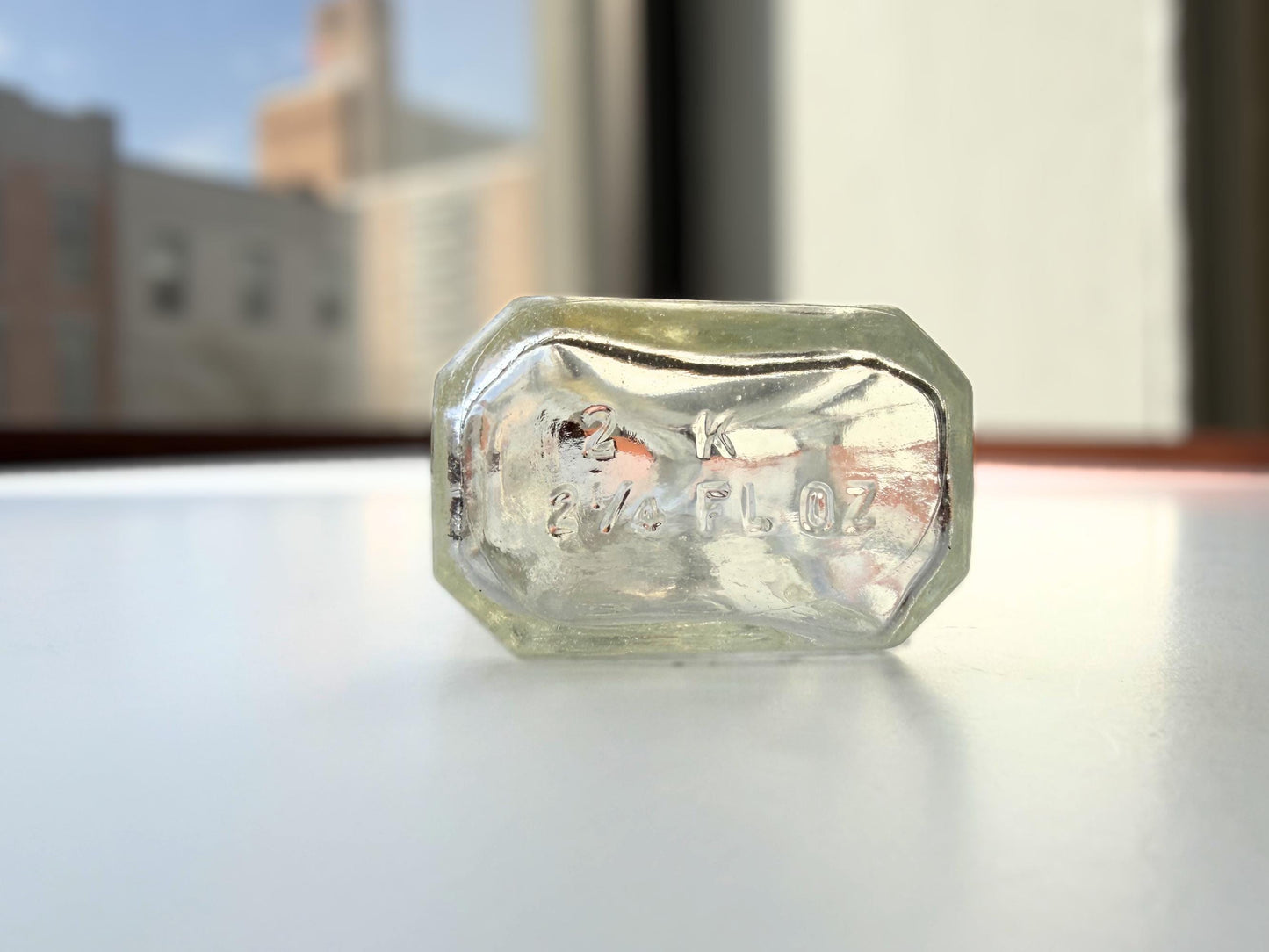 Vintage clear glass Ace shoe polish bottle 4.25 inches tall with bold ace-of-spades embossed logo - mid-century American collector piece hand-recovered from NYC