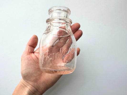 Vintage Borden's clear glass milk bottle, 4.75 inches tall, hand-recovered from NYC mid-century dumping grounds — authentic half-pint dairy bottle with hand-blown character