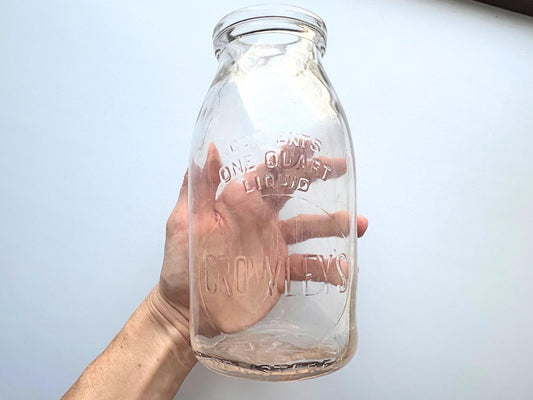 Vintage Crowley's one quart milk bottle with pink tinted glass and embossed Fine Quality lettering. Perfect for farmhouse cottagecore vintage kitchen decor, single stem vase, flower display, or dairy bottle collection. Rescued from NYC beaches.