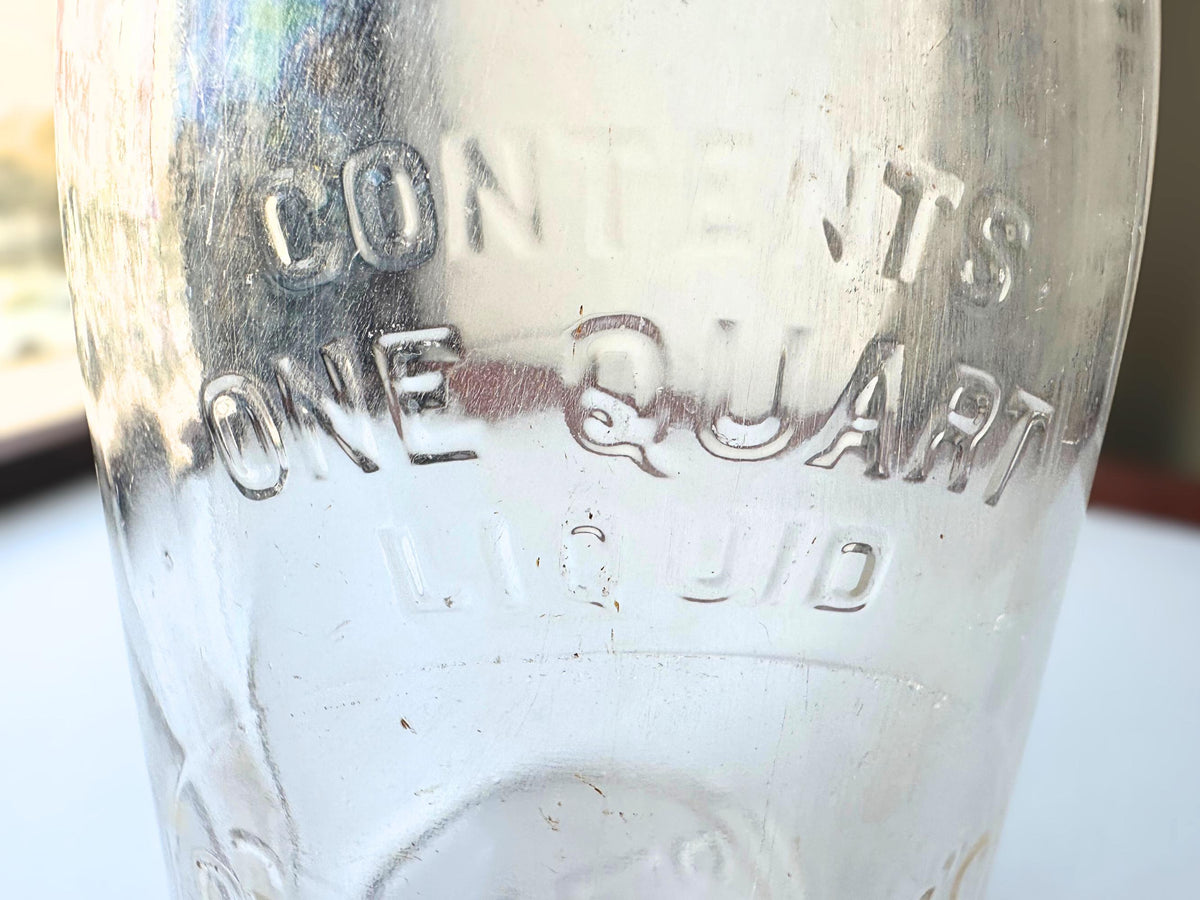 Crowley's bottle side profile showing square quart form and honest vintage surface wear