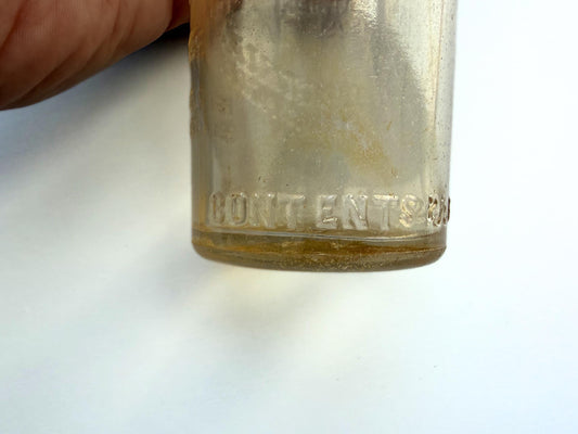 Vintage Garrett and Co Virginia Dare clear glass wine bottle 8.75 inches tall with full-body embossed crest and pre-Prohibition text - hand-recovered from NYC dumping grounds
