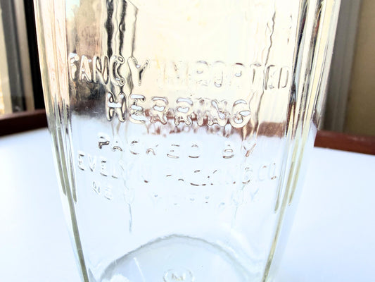 Vintage 1920s-1940s Kingfish Brand clear glass herring jar with bold embossed lettering from Evelyn Packing Company in New York. Perfect for windowsill displays, vintage kitchen collections, and farmhouse or cottagecore decor.