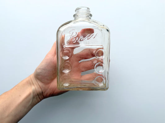 Vintage Purex clear glass bottle with ribbed center panel, rectangular form, and embossed label. Authentic early 20th century household advertising bottle rescued from NYC beaches. Perfect for farmhouse shelving, laundry room decor, bud vase styling.