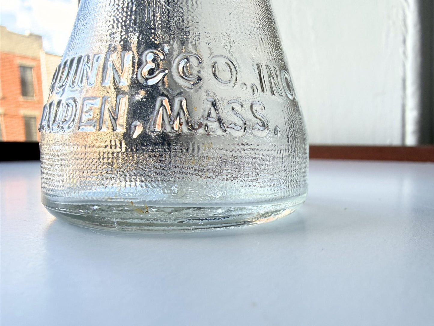 Vintage 1940s-1960s Quintone Scuffy shoe polish bottle with embossed lettering from KJ Quinn and Co Inc Malden Massachusetts. Perfect for vintage product collectors, bathroom displays, and cottagecore decor.