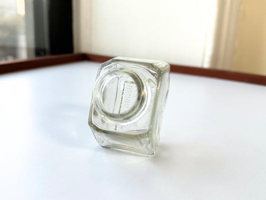 Vintage Waterman's 2oz ink bottle with hexagonal shape and patent marking. Perfect for vintage stationery collectors, office displays, and writing enthusiasts.