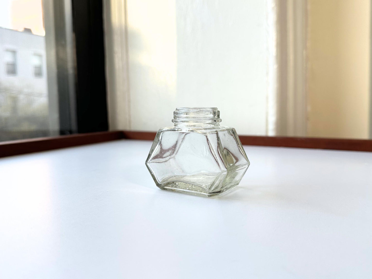 Vintage Waterman's 2oz ink bottle with hexagonal shape and patent marking. Perfect for vintage stationery collectors, office displays, and writing enthusiasts.