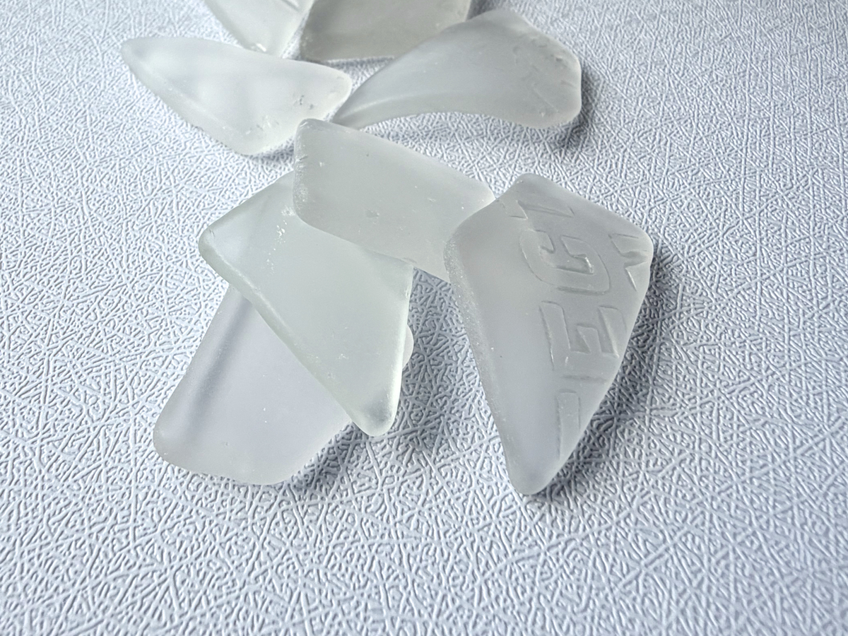 Close-up of antique white tumbled sea glass showing frosted matte texture
