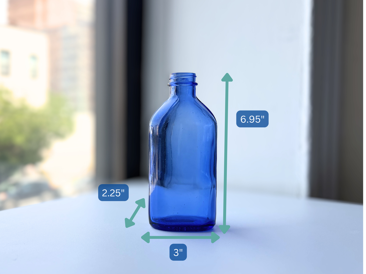 Phillips bottle with dimension overlay showing 6.95 inch height, cobalt blue glass