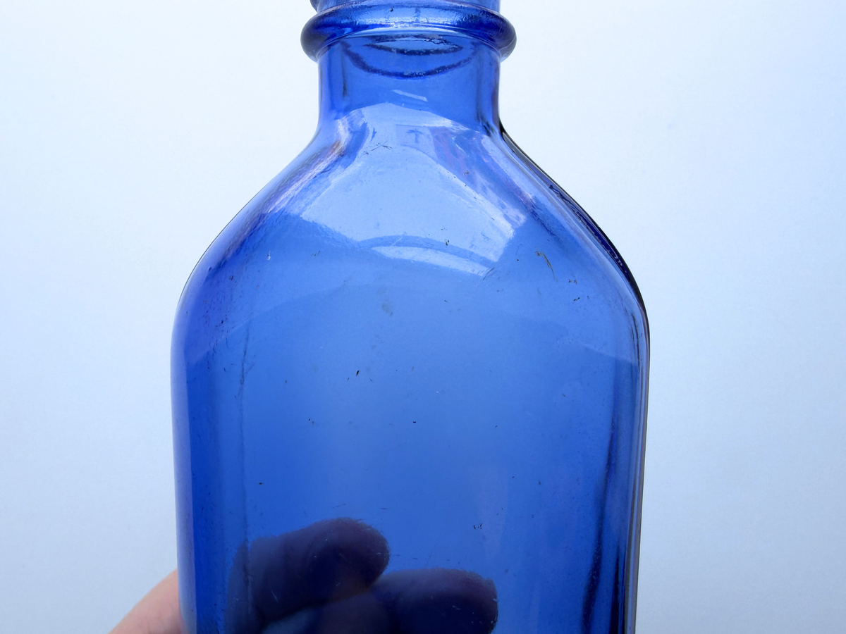 Phillips cobalt blue bottle neck and shoulder detail close-up