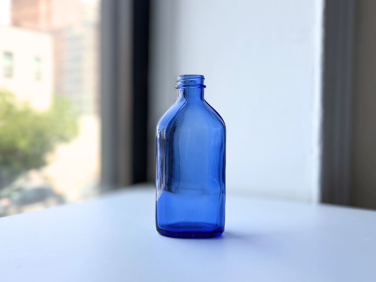 Phillips medium cobalt blue milk of magnesia bottle on windowsill