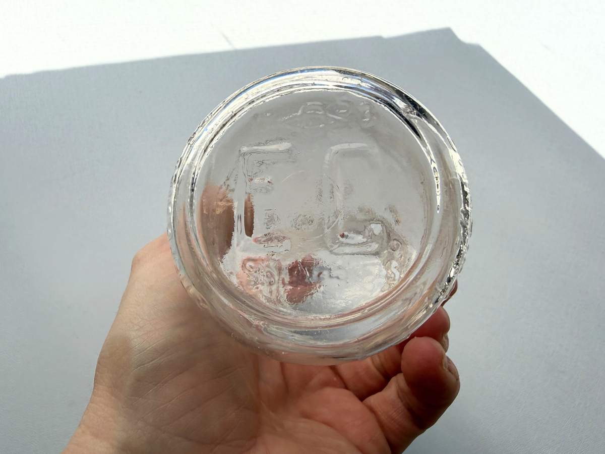 Elmhurst Cream Co. bottle side view showing compact half-pint profile and clear glass condition with minor hazing