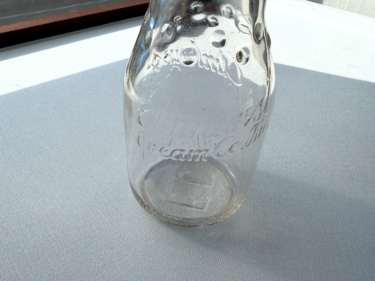 Elmhurst Cream Co. milk bottle top-down view showing round mouth opening and 1953 Queens NY dairy glass form