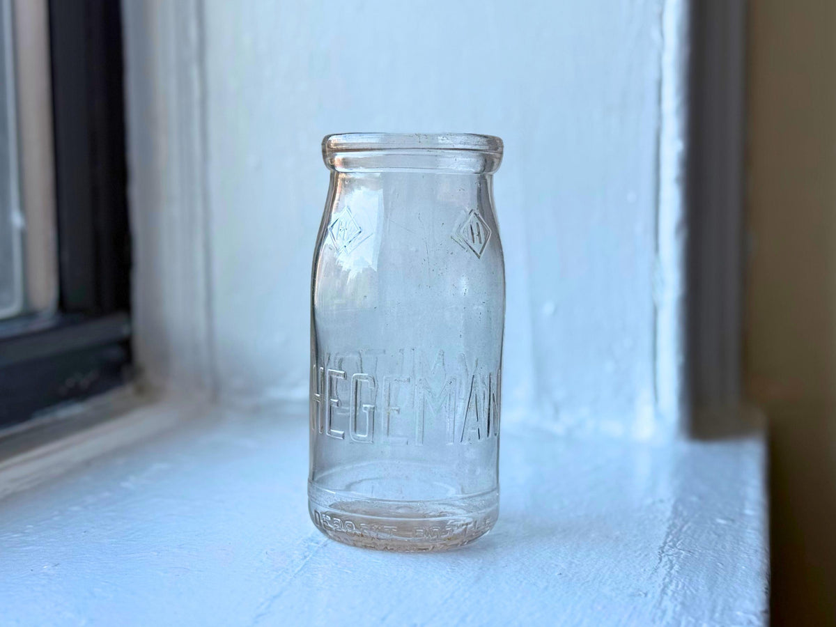 Hegeman Hamilton milk bottle full front view, 1951 Queens NY pint clear glass with diamond H logo