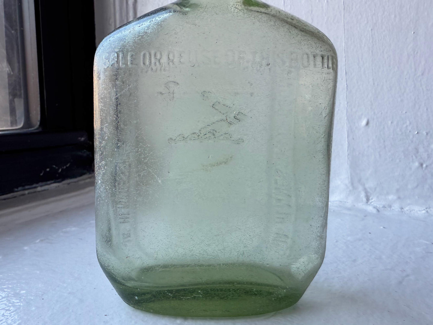 Hennessy 1938 apple green glass bottle back view showing light surface wear, vintage French spirits