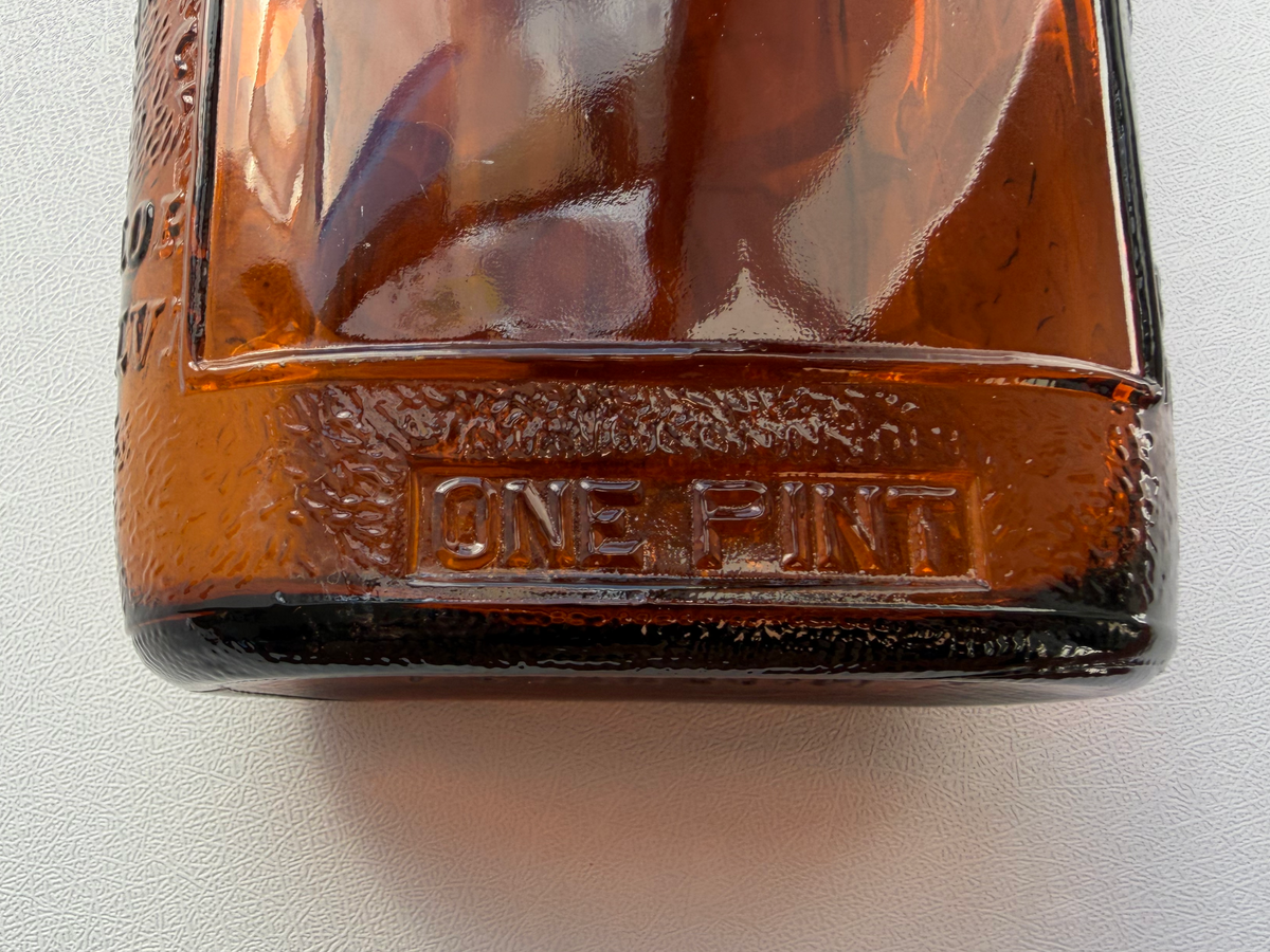 Lord Calvert 1952 amber whiskey flask base markings detail, vintage embossed glass recovered from NYC shoreline