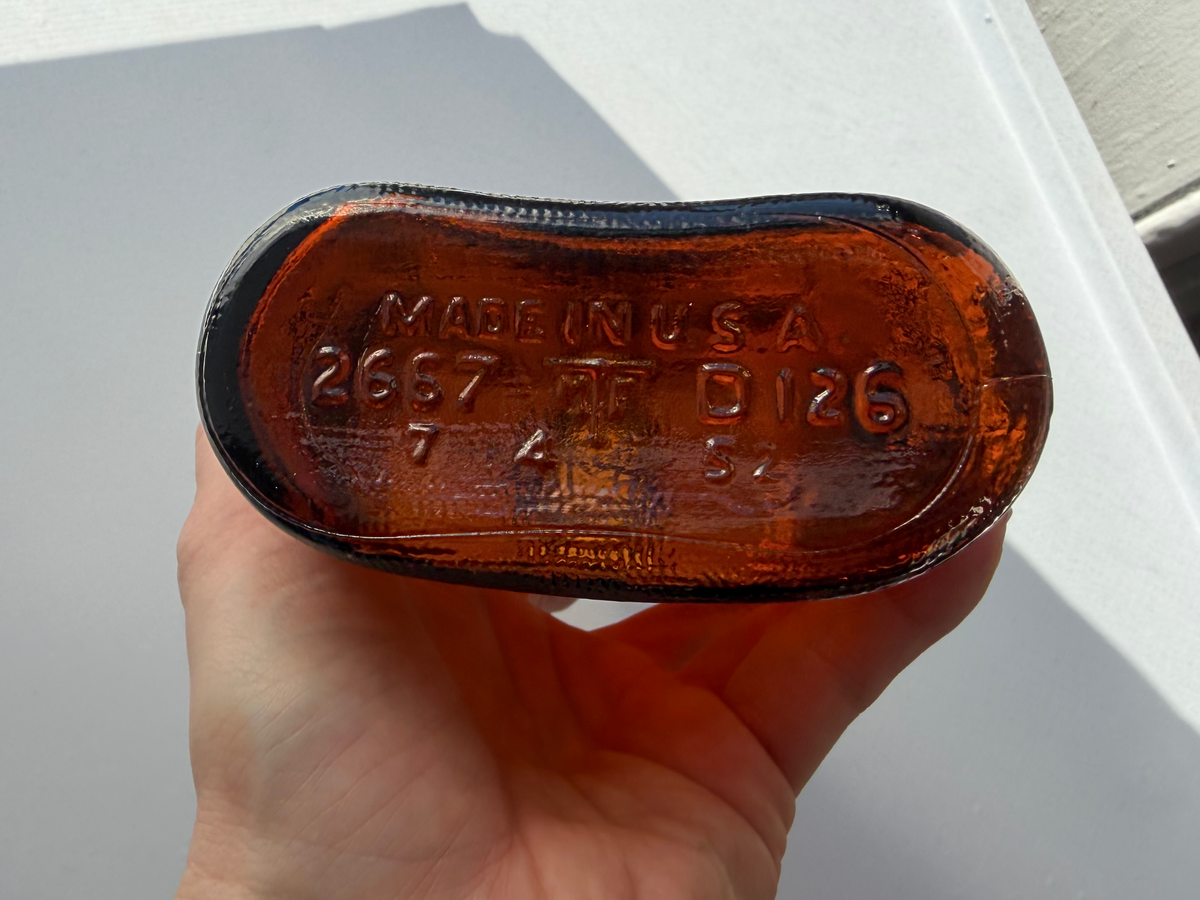 Lord Calvert 1952 amber whiskey flask mouth and top view, vintage amber glass in excellent condition