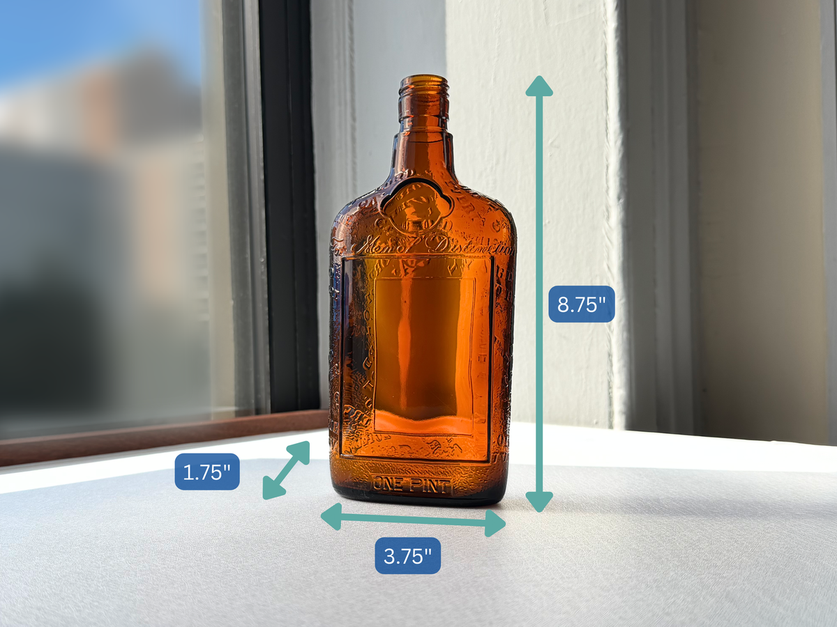 Lord Calvert 1952 amber whiskey flask profile right view, flat embossed glass mid-century bar cart collectible