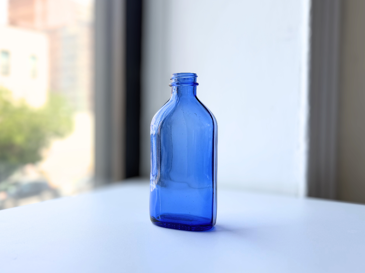Phillips medium cobalt blue milk of magnesia bottle, front view, NYC beach recovery