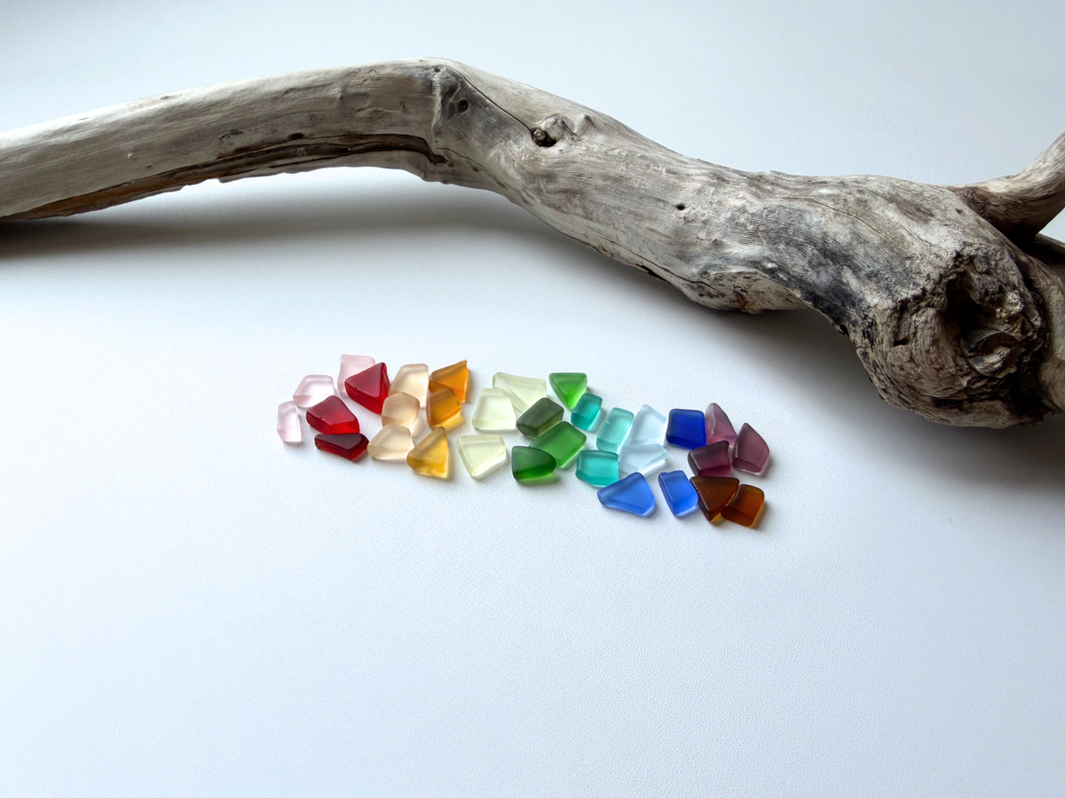 Rainbow-colored extra small tumbled sea glass mix under half an inch in assorted blue, green, amber, and pastel tones with smooth frosted edges, ideal for delicate jewelry making and resin art.