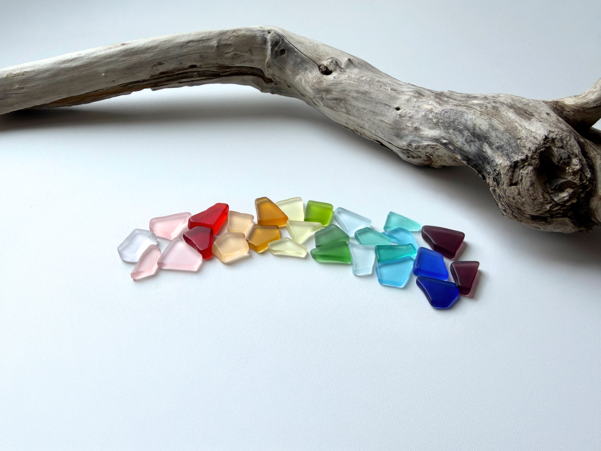 Rainbow-colored small tumbled sea glass mix in blue, green, amber, pink, and brown tones with smooth frosted edges, perfect for jewelry making, mosaics, and coastal home decor.