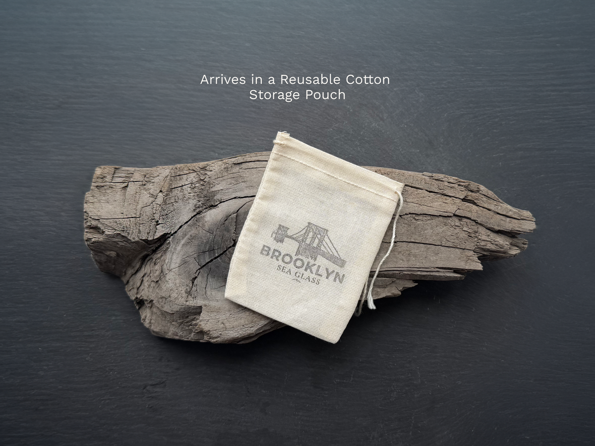 Sea glass pieces packaged in a reusable cotton gift pouch