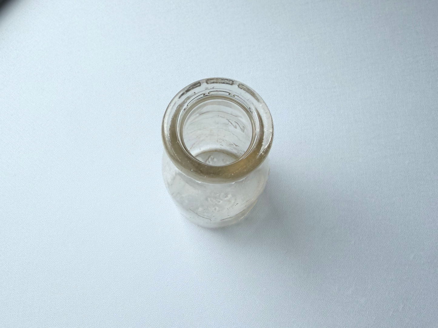 Top-down view of a vintage Grandview Dairy milk bottle, showing the narrow neck opening from above.