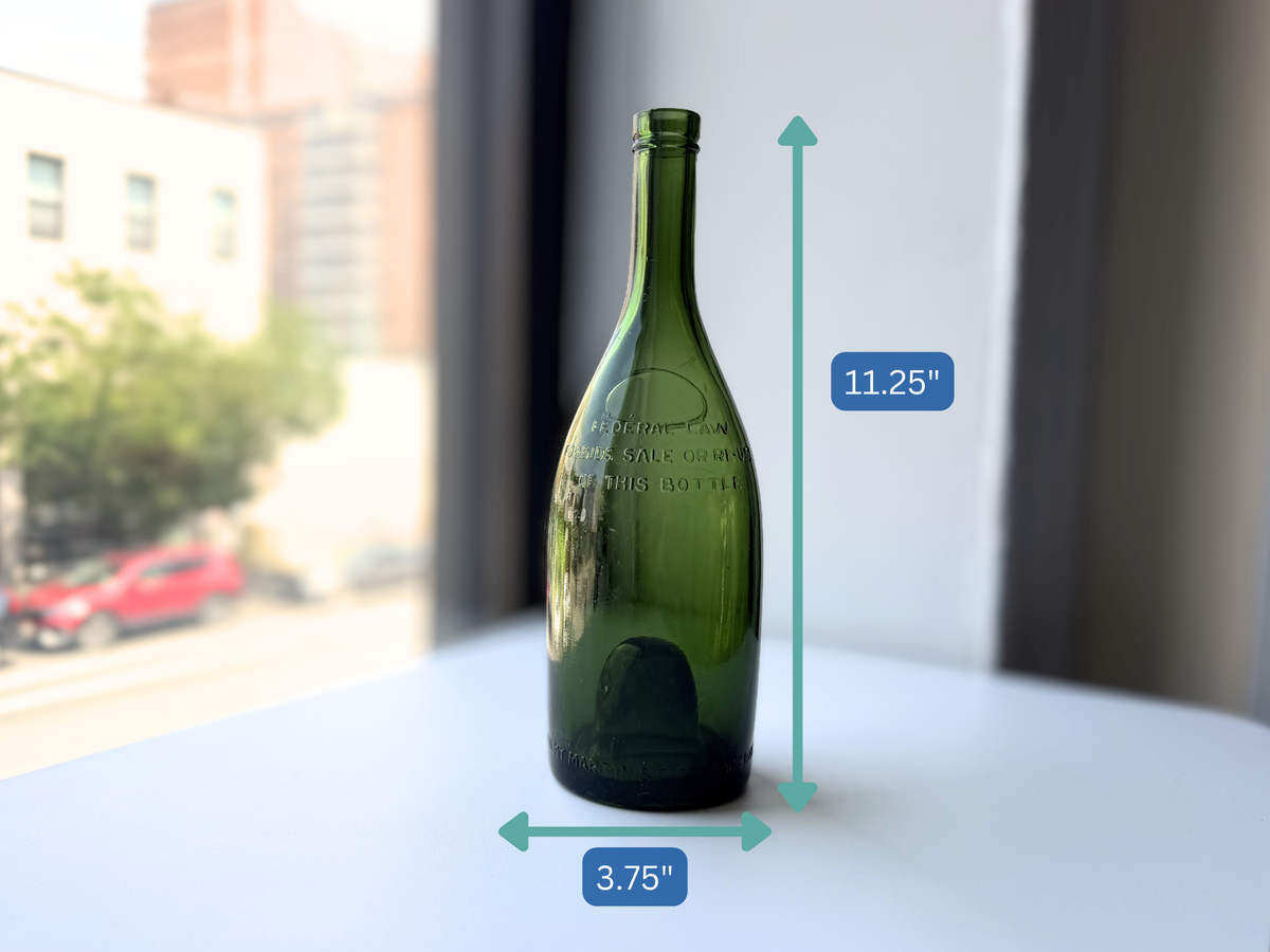Remy Martin green glass bottle with height measurement overlay showing 11.25 inches.