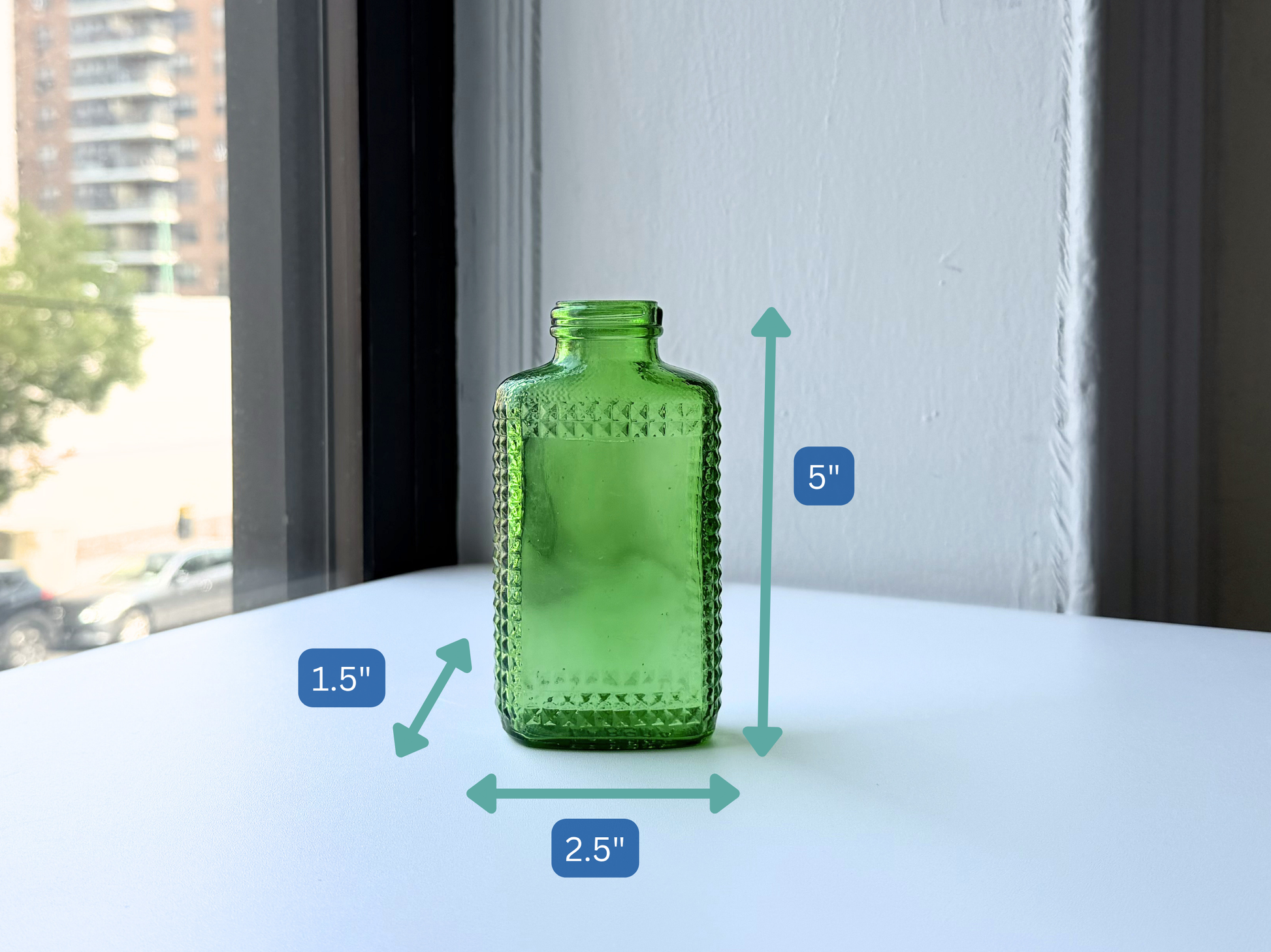 Vintage kelly green Airwick hobnail glass bottle viewed from a side angle
