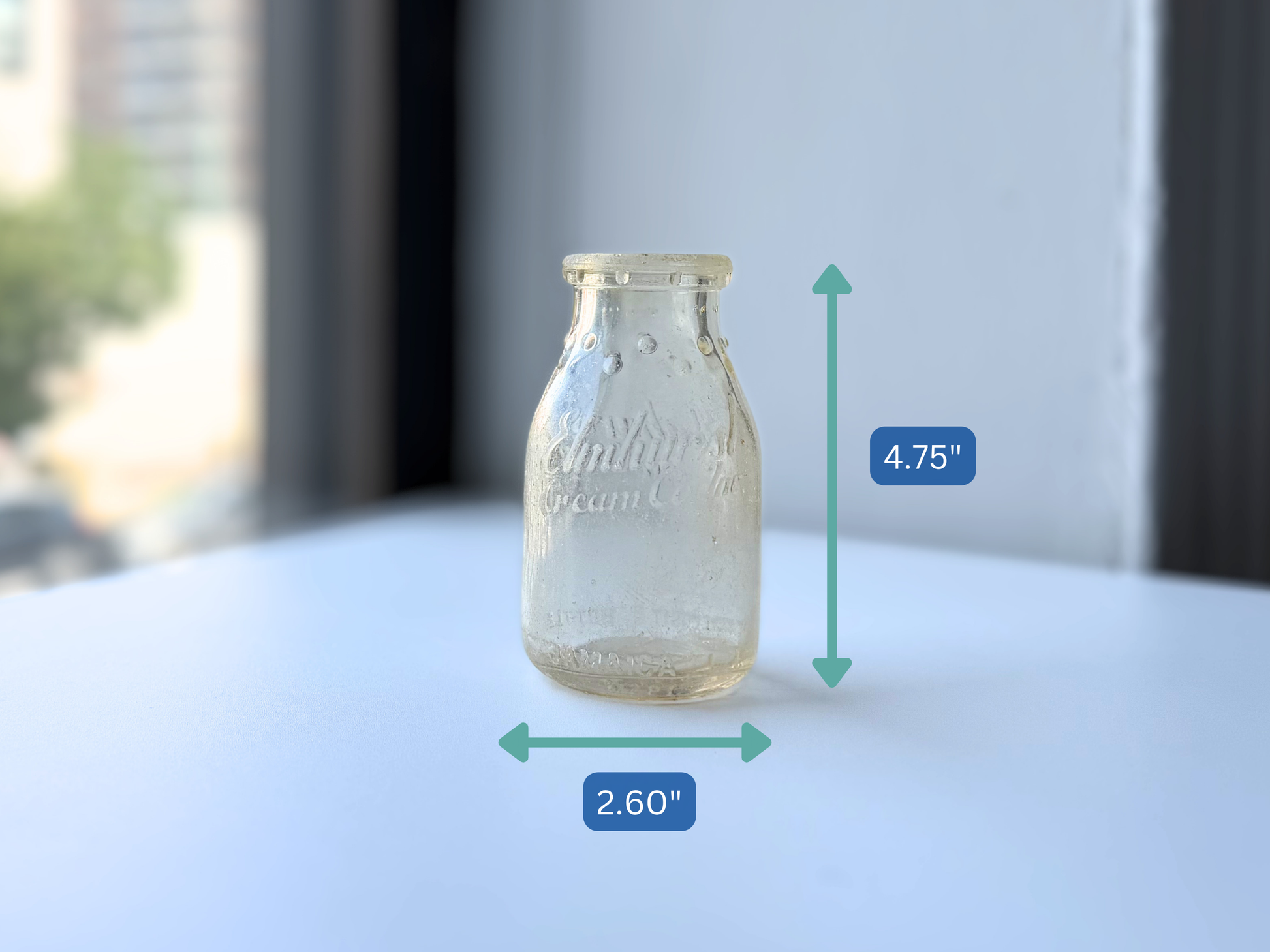 Elmhurst Cream Co sea glass bottle with measurement overlay showing 4.75 inch height and 2.60 inch width