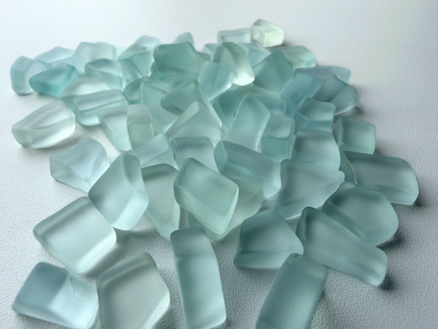Macro view of NYC tumbled sea glass pieces showing flat sides and smooth tumbled edges