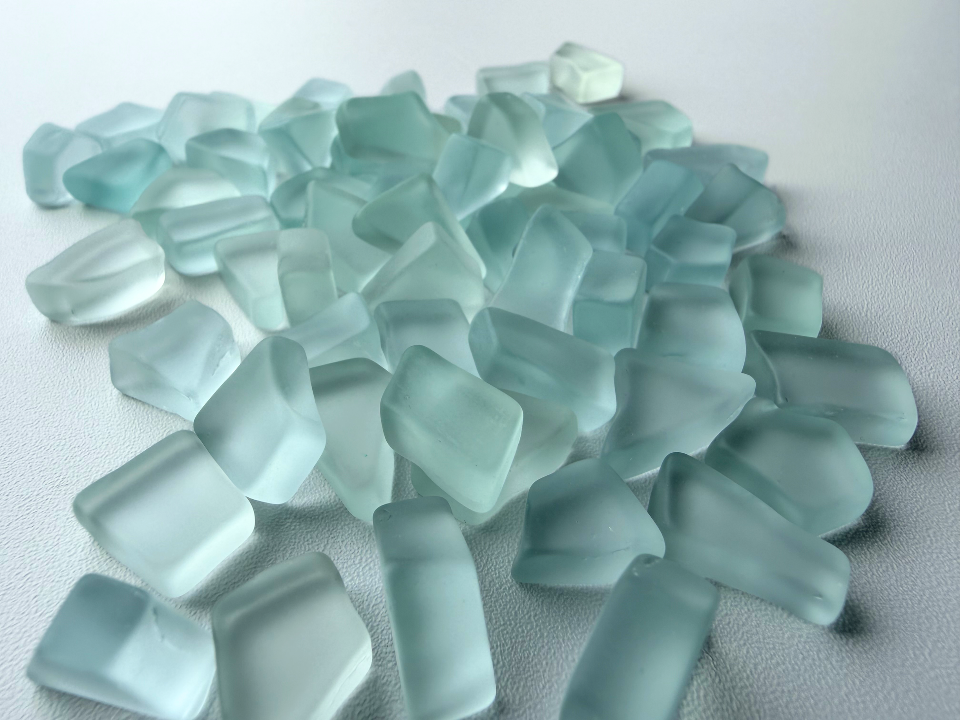 Macro view of NYC tumbled sea glass pieces showing flat sides and smooth tumbled edges
