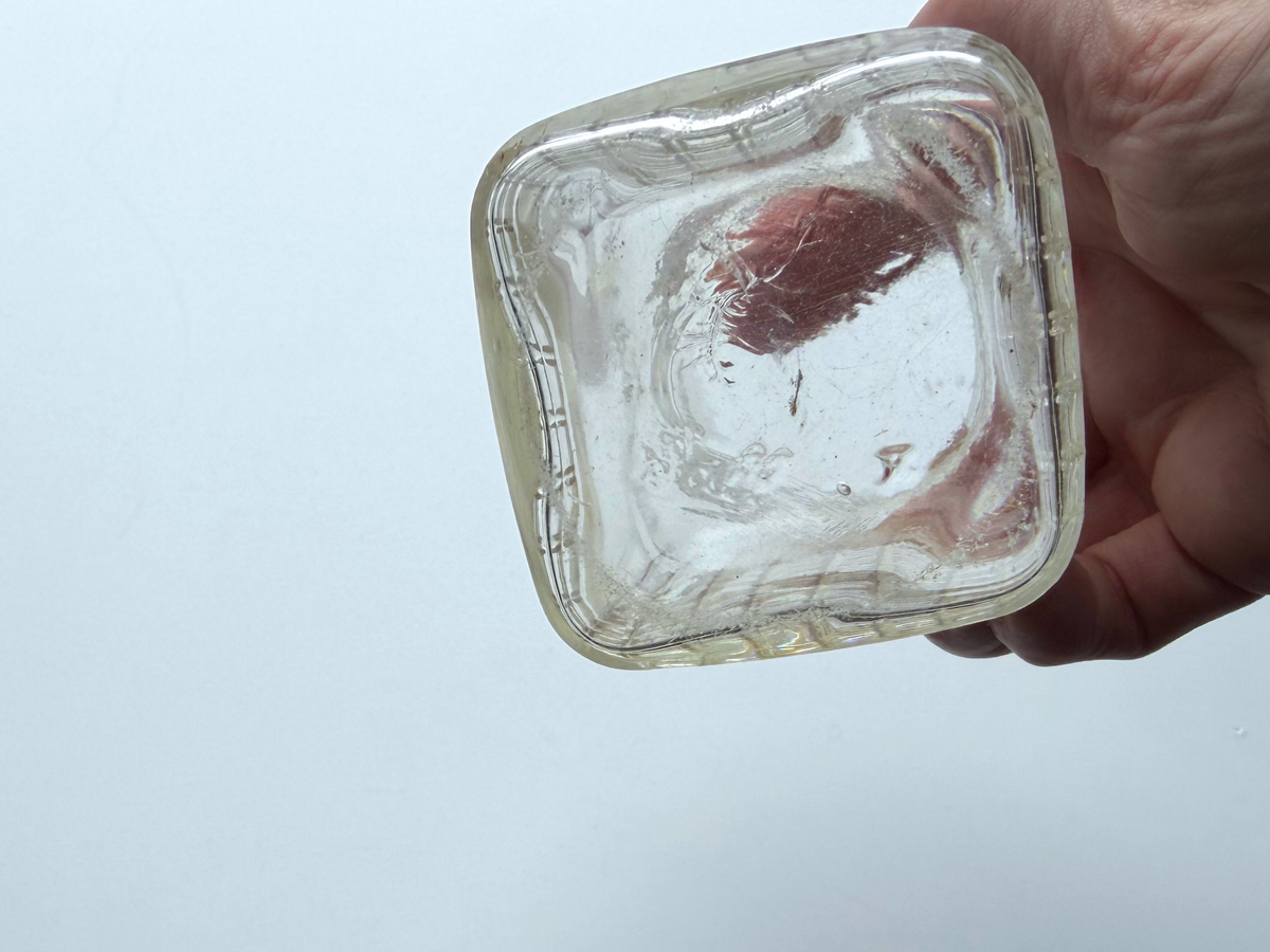 Ball waffle jar base held in hand showing the embossed Ball logo.
